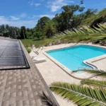 Solar panels installed beside a residential swimming pool