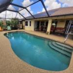 Screened backyard swimming pool at a residential home