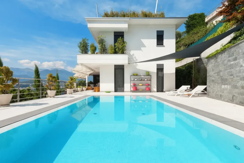 Modern backyard swimming pool beside a contemporary home