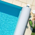 Partially covered swimming pool with a solar pool cover