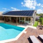 Solar panels installed beside a residential swimming pool
