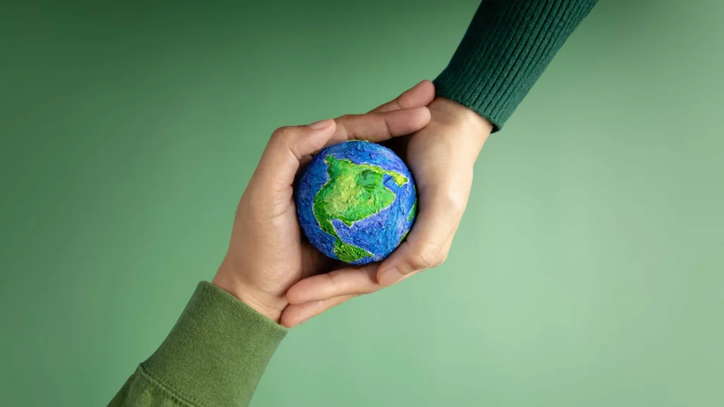 Hands holding a small globe symbolizing sustainability and renewable energy