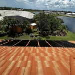 Solar panels installed on a residential roof next to a swimming pool