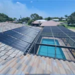 Technician working on solar panels on a residential roof