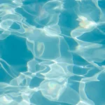 Sunlight reflecting on clear swimming pool water