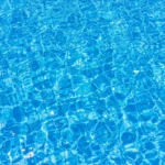 Clear blue swimming pool water surface