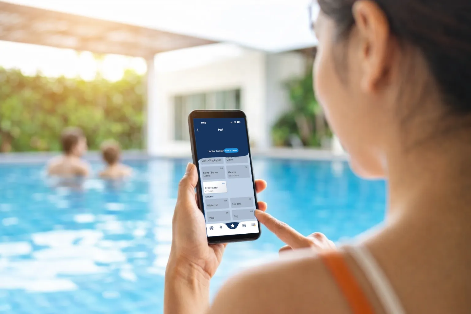 Person using smartphone app near a pool.