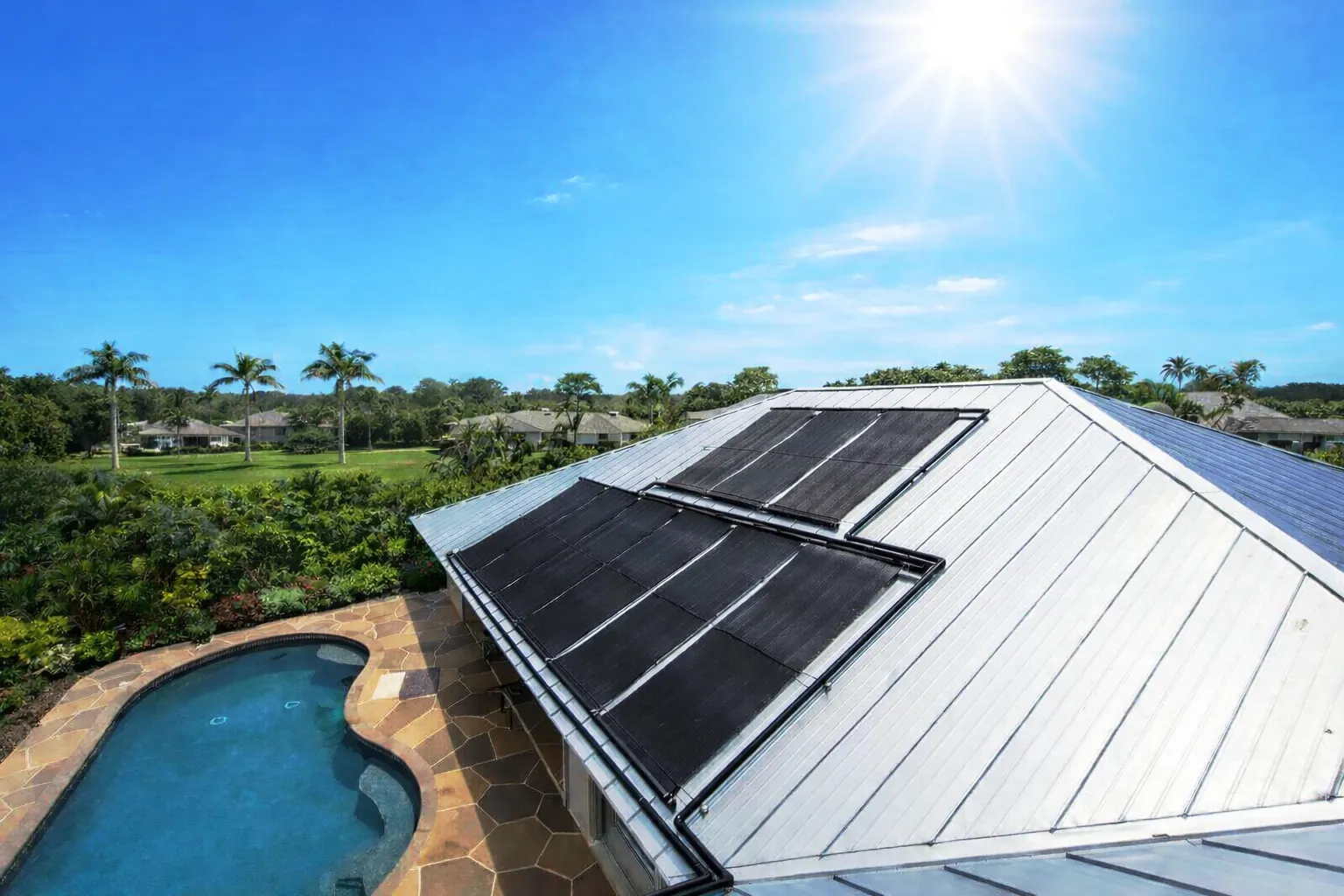 Solar panels installed on a metal roof above a swimming pool