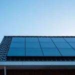 Solar panels installed on a roof against a clear blue sky