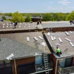 Technician working on solar panels installed on a residential roof