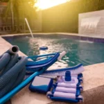 Backyard swimming pool with maintenance equipment beside the water